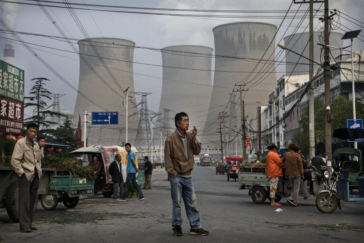 <span class="caption">China is closing old coal plants but still building new ones – at home and abroad.</span> <span class="attribution"><a class="link " href="https://www.gettyimages.com/detail/news-photo/chinese-street-vendors-and-customers-gather-at-a-local-news-photo/800065550" rel="nofollow noopener" target="_blank" data-ylk="slk:Kevin Frayer/Getty Images;elm:context_link;itc:0;sec:content-canvas">Kevin Frayer/Getty Images</a></span>