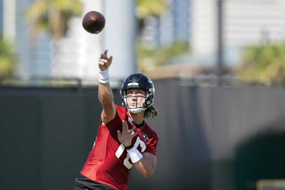 Jacksonville Jaguars quarterback Trevor Lawrence throws a pass during NFL football practice, Saturday, July 31, 2021, in Jacksonville, Fla. (AP Photo/John Raoux)