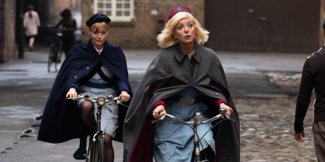 natalie quarry as rosalind clifford and helen george as trixie franklin riding their bikes in their nurses uniform, call the midwife, season 13