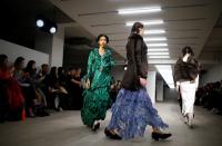 Models present creations during the Yuhan Wang catwalk show at London Fashion Week in London