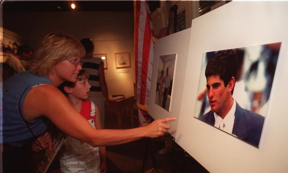 Laura Jochem from Columbus, Ohio, front, points out John F. Kennedy, Jr. to her daughter Hannah 7, during their visit to the John F. Kennedy Hyannis Museum in 1999.