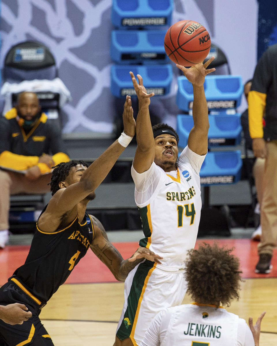 Norfolk State guard Devante Carter (14) beats Appalachian State forward RJ Duhart (4) to a rebound during the first half of a First Four game in the NCAA men's college basketball tournament, Thursday, March 18, 2021, in Bloomington, Ind. (AP Photo/Doug McSchooler)