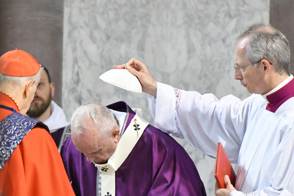 Cardinal prepares the sign of the cross with ashes on the forehead of Pope Francis during the Ash Wednesday mass which opens Lent, the forty-day period of abstinence and deprivation for Christians before Holy Week and Easter, on February 26, 2020, at the Santa Sabina church in Rome. (Photo by Alberto PIZZOLI / AFP) (Photo by ALBERTO PIZZOLI/AFP via Getty Images)
