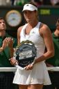 Garbine Muguruza stands with the runners-up shield after losing the Wimbledon women's singles final to Serena Williams on July 11, 2015. Williams won 6-4, 6-4