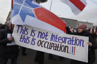 Protesters hold a banner during a rally in downtown Minsk, Belarus, Saturday, Dec. 7, 2019. More than 1,000 opposition demonstrators are rallying in Belarus to protest closer integration with Russia. Saturday's protest in the Belarusian capital comes as Belarusian President Alexander Lukashenko is holding talks with Russian President Vladimir Putin in Sochi on Russia's Black Sea coast. (AP Photo/Sergei Grits)