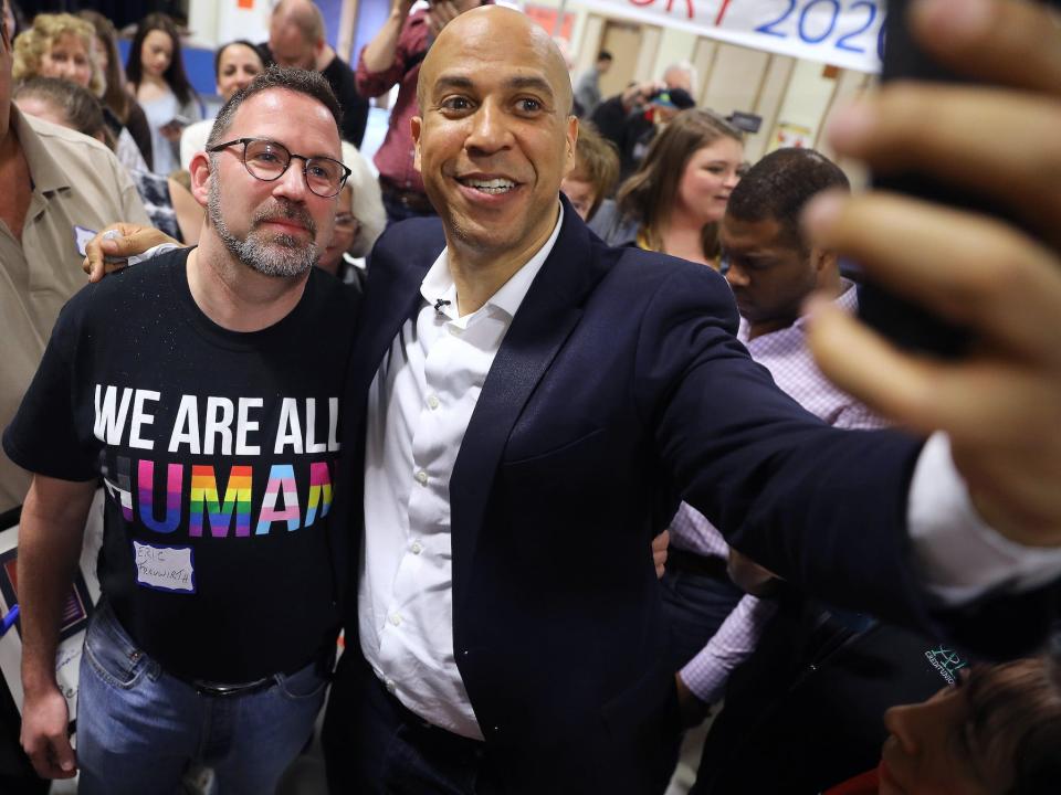 Cory Booker, a 2020 Democratic presidential candidate, takes a selfie with a man in Iowa during a visit there in 2019.