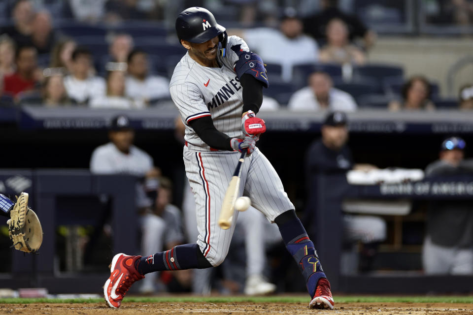 Minnesota Twins' Carlos Correa hits a home run against the New York Yankees during the first inning of a baseball game Thursday, April 13, 2023, in New York. (AP Photo/Adam Hunger)