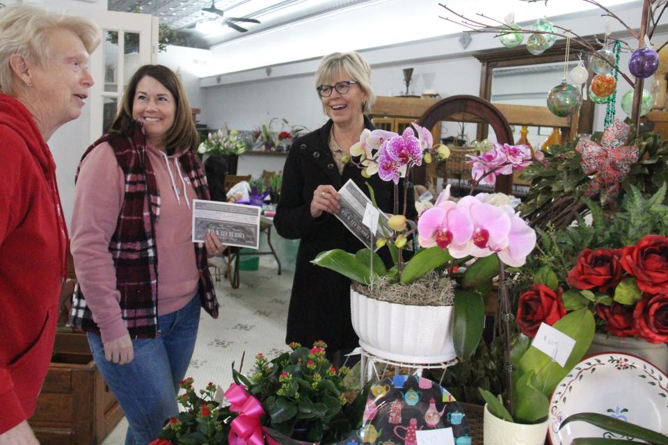 Audi Sorber and Amy Ratje chat with Sandy Seeman at Perry Flowers by Donna Jean during Perry's 20th annual Chocolate Walk on Saturday, Feb. 11, 2023.
