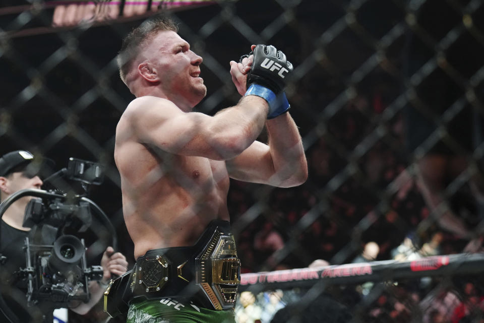 Dricus Du Plessis celebrates after defeating Sean Strickland in a middleweight title bout during the UFC 297 mixed martial arts event in Toronto early Sunday, Jan. 21, 2024. (Nathan Denette/The Canadian Press via AP)