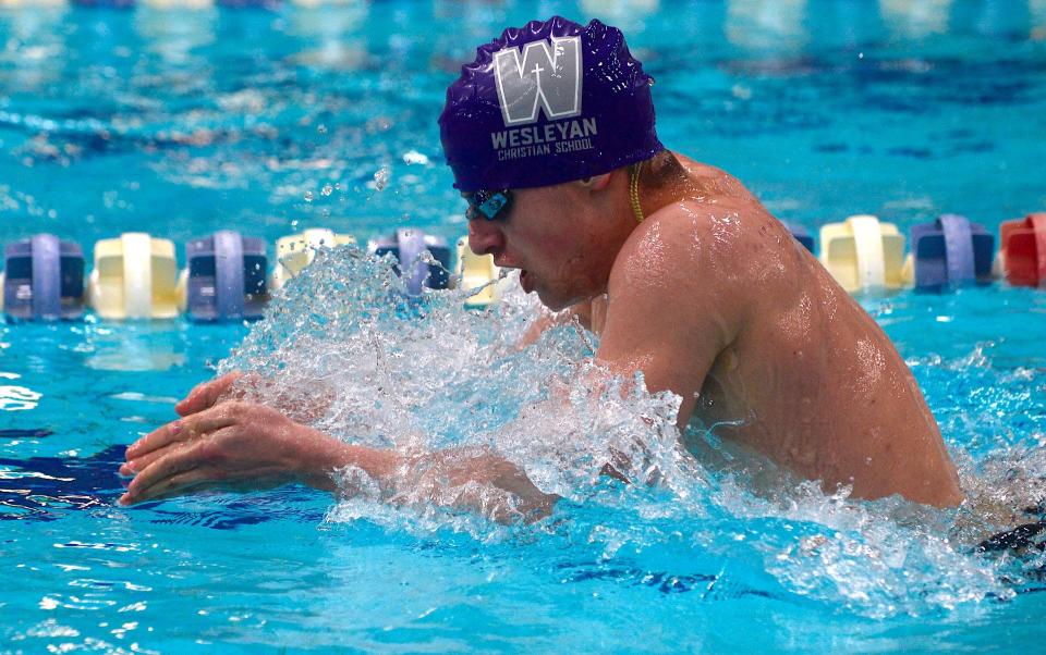 Wesleyan Christian School's Sam Conrad slices through the Adams Pool during a swim competition on Jan. 25, 2023.