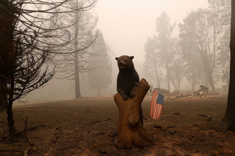 A U.S. flag is seen placed on a wooden bear outside a home that was destroyed in the aftermath of the Beachie Creek fire in Detroit, Oregon