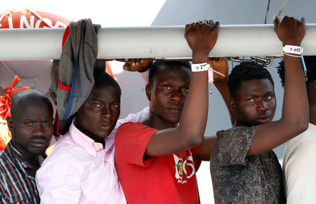 Migrants wait to disembark from the Italian Navy vessel Sfinge in the Sicilian harbour of Pozzallo, southern Italy, August 31, 2016. REUTERS/ Antonio Parrinello