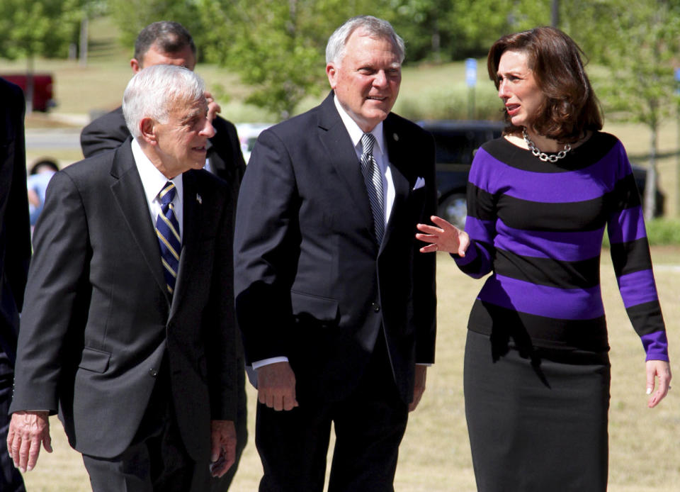 FILE - In this April 25, 2012, file photo, retired Lt. Gen. Carmen Cavezza, left, Georgia Gov. Nathan Deal, center, and Columbus Mayor Teresa Tomlinson walk into the National Infantry Museum and Soldier Center in Fort Benning, Ga. Tomlinson, a Georgia Democrat and former Columbus mayor, announced Wednesday, May 1, 2019, that she's officially running for a U.S. Senate seat in 2020, just one day after fellow Democrat Stacey Abrams announced she wouldn't run. (Joe Paull/Ledger-Enquirer via AP)