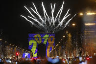 <p>A firework explodes over the Arc de Triomphe as part of the New Year celebrations on the Champs Elysees, in Paris, France, Monday, Jan. 1, 2018. (Photo: Thibault Camus/AP) </p>