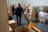 An employee prepares an order for Amazon at Porona warehouse in Bruay-sur-l'Escaut