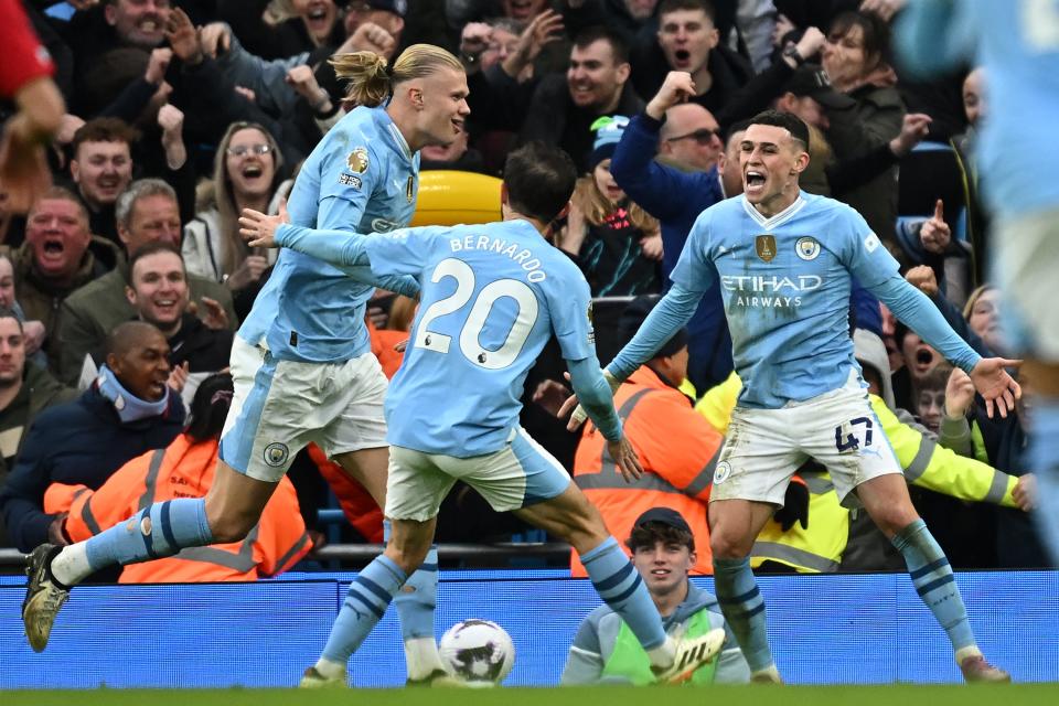 TOPSHOT - Manchester City's Norwegian striker #09 Erling Haaland (L) celebrates with Manchester City's Portuguese midfielder #20 Bernardo Silva (C) and Manchester City's English midfielder #47 Phil Foden (R) after scoring their third goal during the English Premier League football match between Manchester City and Manchester United at the Etihad Stadium in Manchester, north west England, on March 3, 2024. (Photo by Paul ELLIS / AFP) / RESTRICTED TO EDITORIAL USE. No use with unauthorized audio, video, data, fixture lists, club/league logos or 'live' services. Online in-match use limited to 120 images. An additional 40 images may be used in extra time. No video emulation. Social media in-match use limited to 120 images. An additional 40 images may be used in extra time. No use in betting publications, games or single club/league/player publications. / (Photo by PAUL ELLIS/AFP via Getty Images)