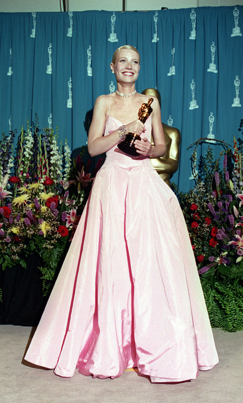 <p>The dress that divided the nation in 1999. Was Gwyneth’s pink Ralph Lauren dress a sweet, appropriate dress for a young actress picking up her first Oscar, or an ill-fitting, wrinkled prom queen nightmare? The debate rages on. (Photo: PA) </p>