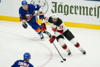 New Jersey Devils' Nico Hischier (13) drives past New York Islanders' Leo Komarov (47) and Jordan Eberle during the first period of an NHL hockey game Saturday, May 8, 2021, in Uniondale, N.Y. (AP Photo/Frank Franklin II)