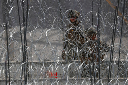 U.S. Marines help to build a concertina wire barricade at the U.S. Mexico border in preparation for the arrival of a caravan of migrants at the San Ysidro border crossing in San Diego, California, U.S., November 13, 2018. REUTERS/Mike Blake