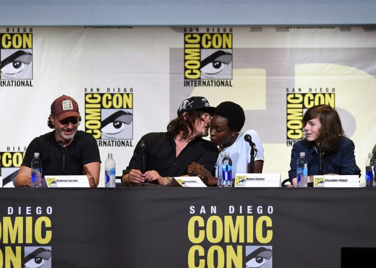 (L-R) Andrew Lincoln, Norman Reedus, Danai Gurira, and Chandler Riggs attend AMC's "The Walking Dead" panel during Comic-Con International 2016 in San Diego, California