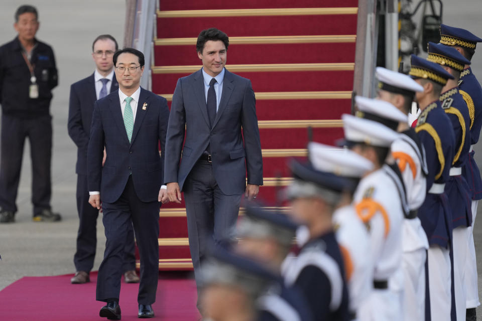 Canadian Prime Minister Justin Trudeau, center, is escorted by South Korea's Special Representative for Korean Peninsula Peace and Security Affairs Kim Gunn, left, upon his arrival at the Seoul airport in Seongnam, South Korea, Tuesday, May 16, 2023. Trudeau arrived Tuesday in South Korea and will meet with South Korean President Yoon Suk Yeol, before heading to Japan for a G7 summit. (AP Photo/Lee Jin-man)