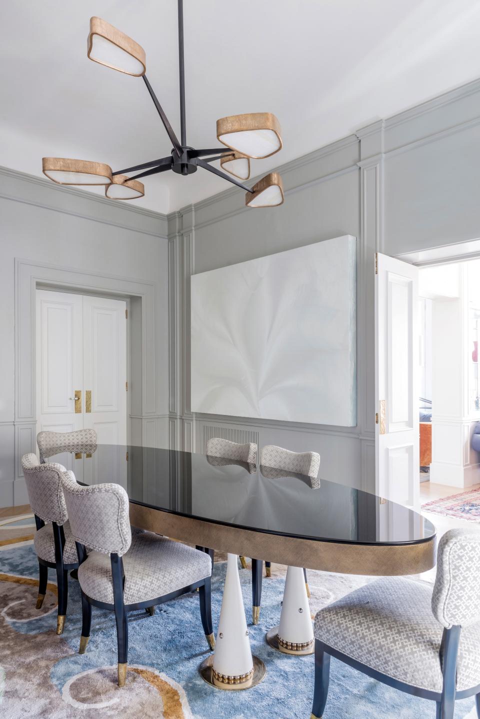 The chandelier that hangs above the dining table, a bronze, onyx, and 24-carat-gold limited-edition piece called Spider, is one of Salvagni’s most emblematic designs. “I love to read about the history of design; this was a sort of homage to Italian style in the ’40s and ’50s,” he says. “I work with very heavy materials, but I like to make them seem light.” In the background is a one-of-a-kind white work by Jason Martin, a British artist known for his brightly colored, thickly textured paintings.