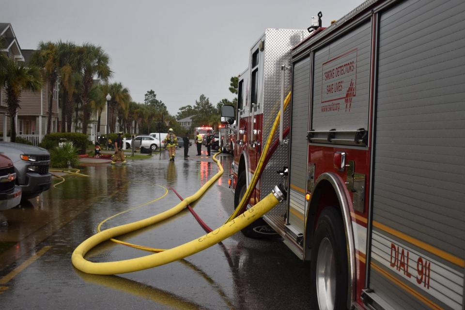 South Walton Fire District crews extend several lines of hose to fight a fire at a home on Enchanted Way in Santa Rosa Beach. The fire was believed to be caused by a lightning strike.