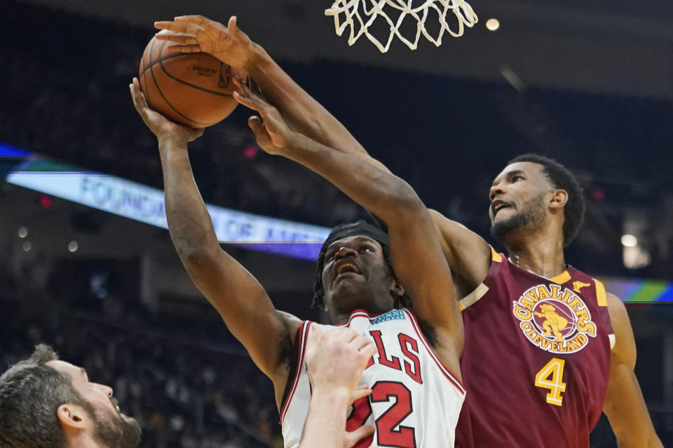 Cleveland Cavaliers' Evan Mobley (4) blocks a shot by Chicago Bulls' Alize Johnson (22) in the first half of an NBA basketball game, Wednesday, Dec. 8, 2021, in Cleveland. (AP Photo/Tony Dejak)