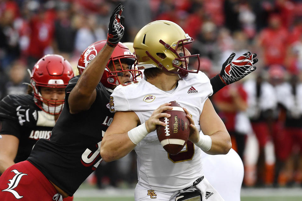 Boston College quarterback Dennis Grosel (6) is sacked by Louisville defensive lineman Ryheem Craig (32) during the first half of an NCAA college football game in Louisville, Ky., Saturday, Oct. 23, 2021. (AP Photo/Timothy D. Easley)