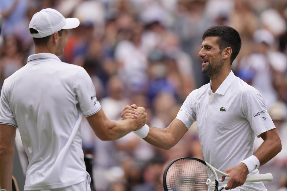 Serbia's Novak Djokovic, right, greets Poland's Hubert Hurkacz at the net after beating him in a men's singles match on day eight of the Wimbledon tennis championships in London, Monday, July 10, 2023. (AP Photo/Alberto Pezzali)