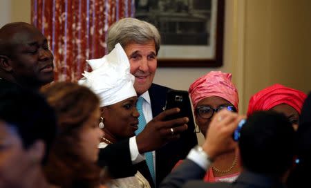 U.S. Secretary of State John Kerry poses for a selfie after delivering remarks on the 2016 Trafficking in Persons (TIP) Report during the TIP Heroes Ceremony at the State Department in Washington June 30, 2016. REUTERS/Kevin Lamarque