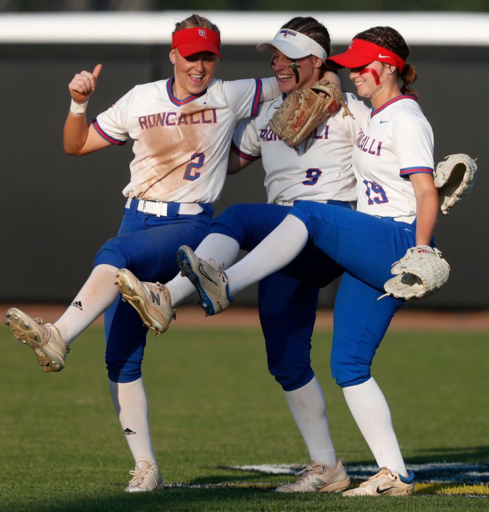 Roncalli Royals Lyla Blackwell (2), Roncalli Royals Abbey Hofmann (9) and Roncalli Royals Emma Fegan (19) celebrate during the IHSAA Class 4A Softball State Final against the Penn Kingsmen, Saturday, June 10, 2023, at Purdue University’s Bittinger Stadium in West Lafayette, Ind. Penn won 2-1 in nine innings.