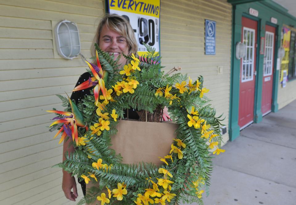 Adriana Pustea, of Harwich, shows the items she bought Sunday at the Christmas Tree Shops in West Dennis, which closed forever on Sunday.