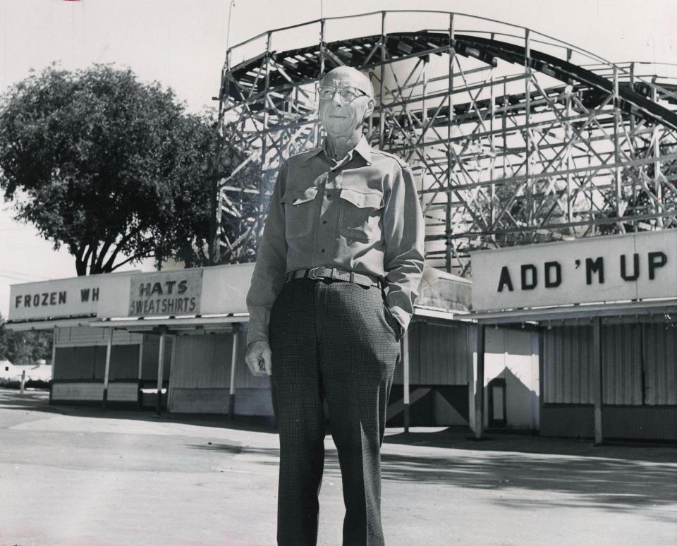 Chippewa Lake Park owner Parker Beach stands in front of the park's rollercoaster.