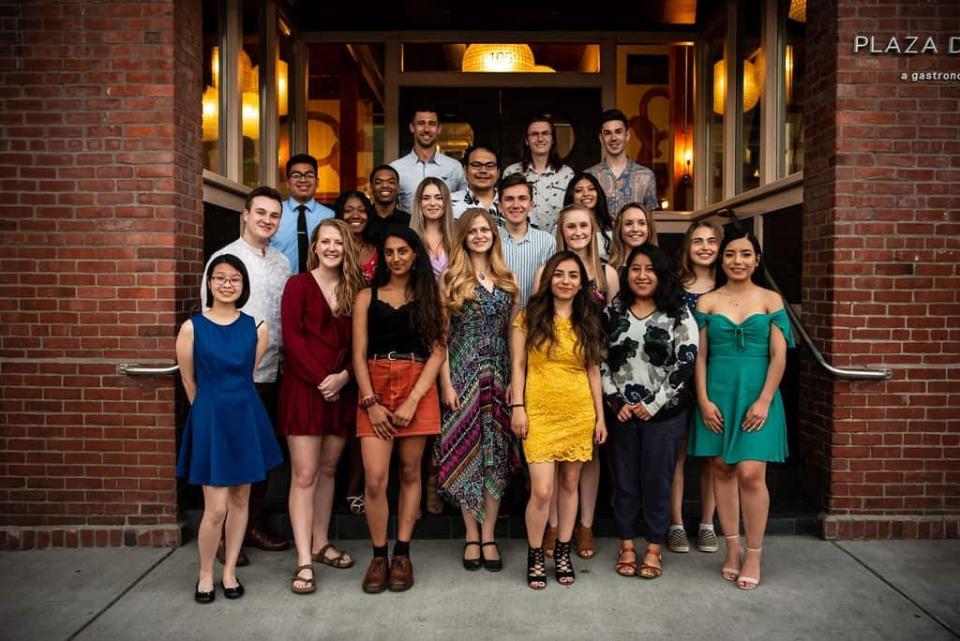 Former Lions quarterback Joey Harrington, back left, poses with students from the college scholarship and mentoring program of the Harrington Family Foundation.