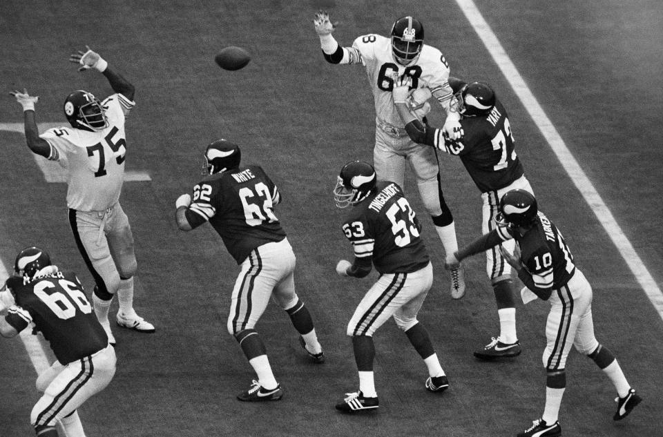 FILE - In this Jan. 12, 1975, file photo, Pittsburgh Steelers tackle Joe Greene (75) defends a pass as Minnesota Viking players Andy Maurer (66), Ed White (62), Mick Tingelhoff (53) and Ron Yary (73) protect quarterback Fran Tarkenton (10) during NFL football's Super Bowl IX at Tulane Stadium New Orleans, La. Tingelhoff, the ultimate ironman who started 240 consecutive games at a bruising position for the Minnesota Vikings and played in four Super Bowls, died, the Vikings and the Pro Football Hall of Fame announced, Saturday, Sept. 11, 2021. He was 81. (AP Photo/Harry Hall, File)