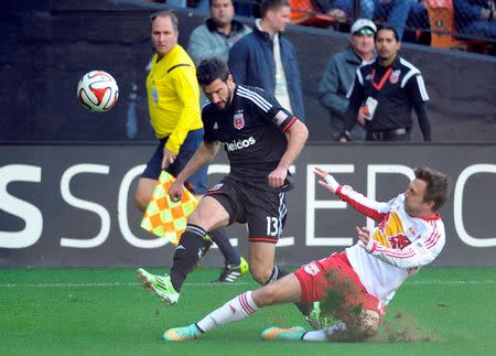 Nov 8, 2014; Washington, DC, USA; New York Red Bulls midfielder Eric Alexander (12) kicks the ball away from D.C. United midfielder/forward Chris Pontius (13) during the first half at Robert F. Kennedy Memorial. Mandatory Credit: Brad Mills-USA TODAY Sports