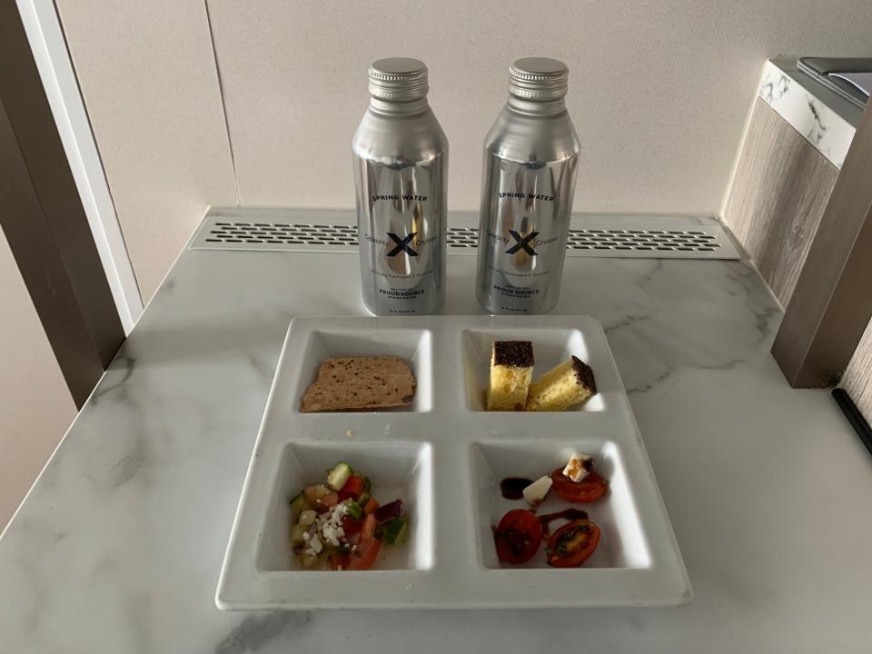 small plate of snacks with two bottles