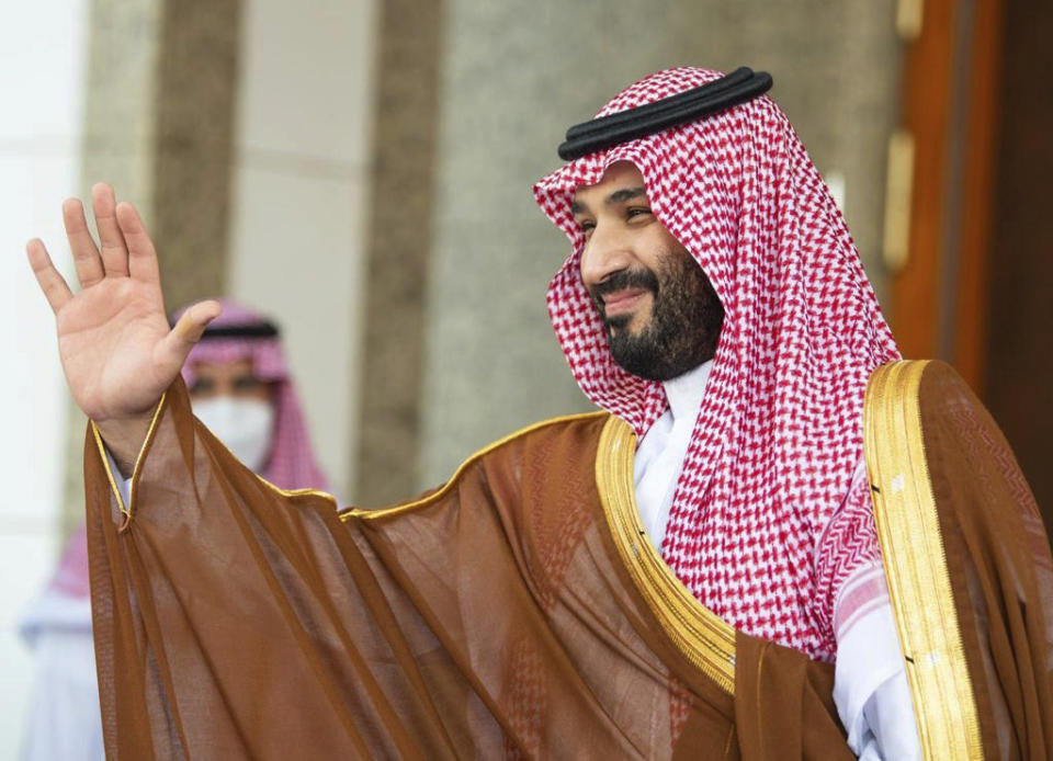 FILE - In this photo released by Saudi Royal Palace, Saudi Crown Prince Mohammed bin Salman, waves to French President Emmanuel Macron, upon his arrival in Jiddah, Saudi Arabia, Dec. 4, 2021. Saudi Arabia’s crown prince was heading Monday, Dec. 6, 2021, to Oman, the first stop of a tour of Gulf Arab states that will see him meet neighboring rulers and allies as the kingdom closely watches negotiations in Europe to revive Iran’s nuclear deal with world powers. (Bandar Aljaloud/Saudi Royal Palace via AP, File)