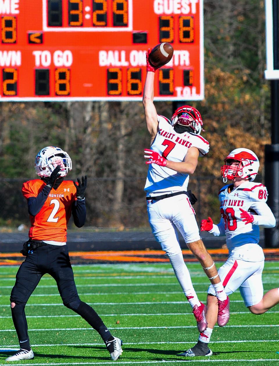 Milford’s Aidan Watson intercepts a pass intended for Taunton’s Braden Mullen during Thursday’s Thanksgiving Day game.