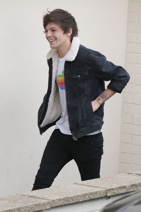 Louis Tomlinson wearing a rainbow Apple logo T-Shirt. Photo: Splash Images