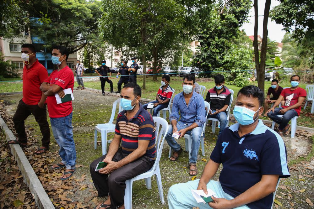 Foreign workers wait to be screened for Covid-19 in Taman Langat Murni, Kuala Langat June 4, 2020. — Picture by Yusof Mat Isa