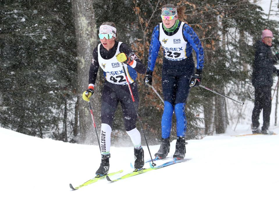 Middlebury's Ava Schneider (42) leads U-32's Olivia Serrano (29) thru the woods during the Nordic classic race at the Vermont State championships on Tuesday morning at the Rikert Outdoor Center. 