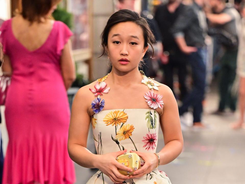 Cathy Ang wears a floral dress on the set of "And Just Like That..." in July 2021.