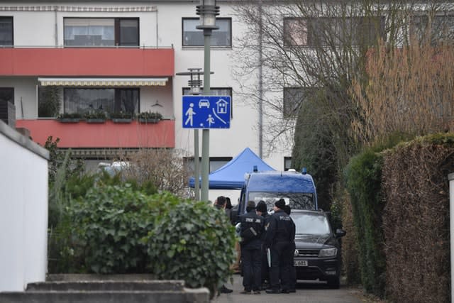 Police officers at the house where the suspected perpetrator was found dead after a series of deadly shootings in Hanau, Germany