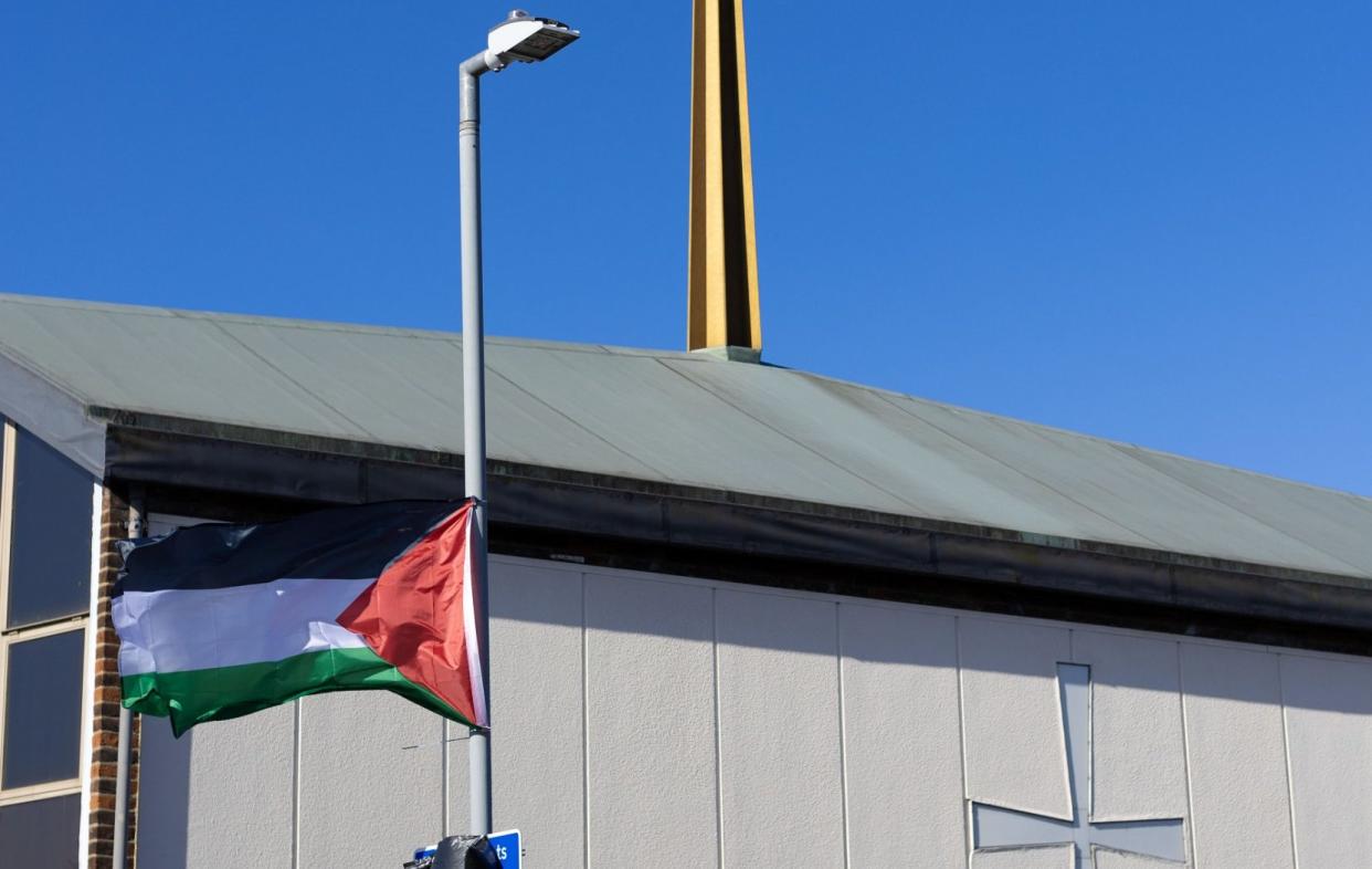 A flag flies near an Ilford church hall in which a polling station has been set up