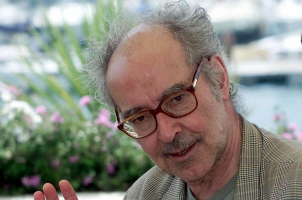 FILE - Film director Jean Luc Godard waves during a photo call at the festival palace in Cannes, France, Tuesday, May 15, 2001. Director Jean-Luc Godard, an icon of French New Wave film who revolutionized popular 1960s cinema, has died, according to French media. He was 91. Born into a wealthy French-Swiss family on Dec. 3, 1930, in Paris, the ingenious "enfant terrible" stood for years as one of the world's most vital and provocative directors in Europe and beyond — beginning in 1960 with his debut feature "Breathless." (AP Photo/Laurent Rebours, File)