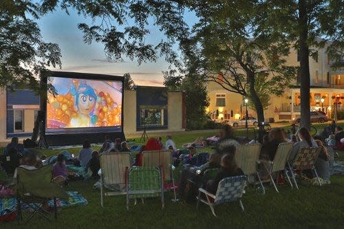 A crowd gathers to watch a movie hosted in downtown Petoskey as part of the city's Summer Celebration event.