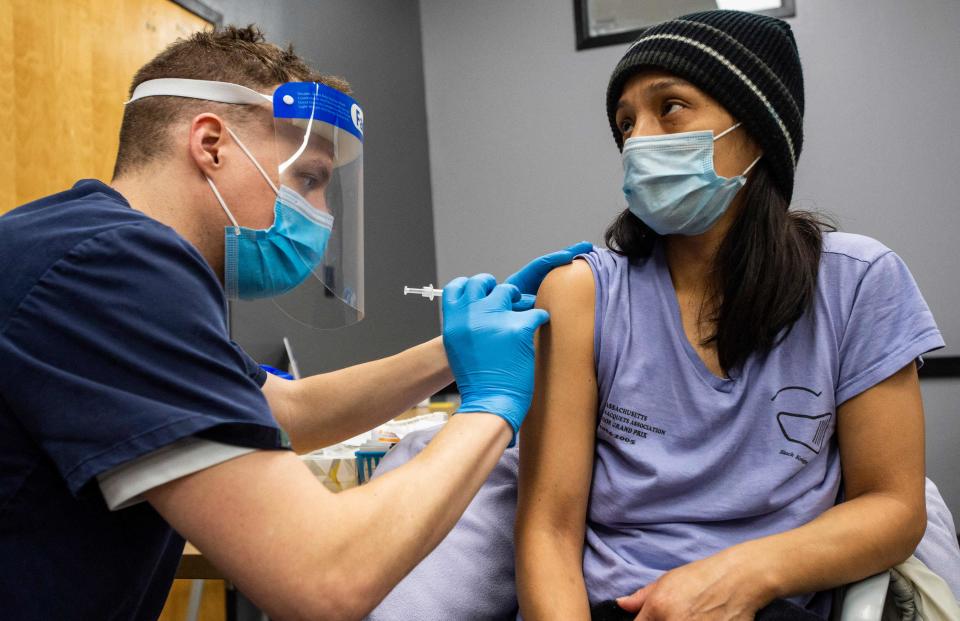 Edith Arangoitia is vaccinated with the Pfizer-BioNTech COVID-19 vaccine at La Colaborativa in Chelsea, Mass., on Feb. 16, 2021.