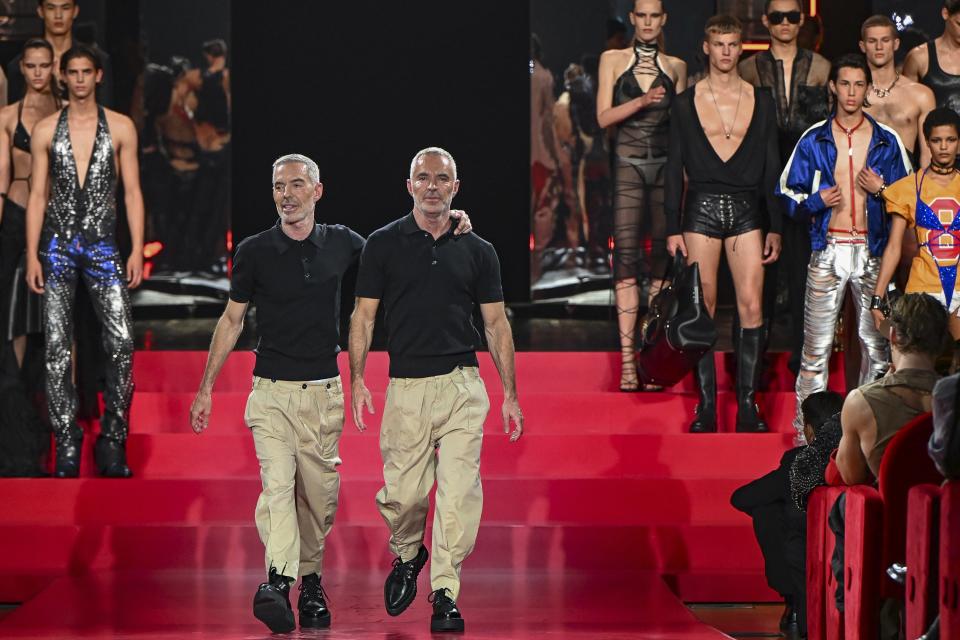 Designers Dean Caten and Dan Caten accept applause after the DSquared2 Spring Summer 2025 collection, that was presented in Milan, Italy, Friday, June 14, 2024. (AP Photo/Nicola Marfisi).